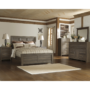 Ashley B251 Bedroom Set Juararo by ashley with nightstand chest dresser and mirror in image and wood paneling throughout product image