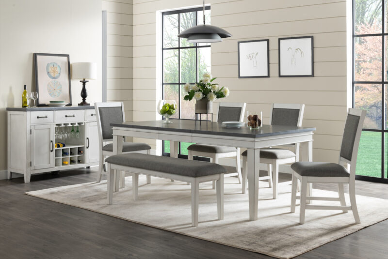 Del Mar Dining Table 6 Piece Lifestyle with Server by martin Svensson product image with a white base and grey table top and grey upholstered seats. Wine rack on the server with 3 drawers and 2 cabinets.